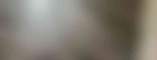 Detail of the vinyl plank edges and seams in a newly finished gray floor.