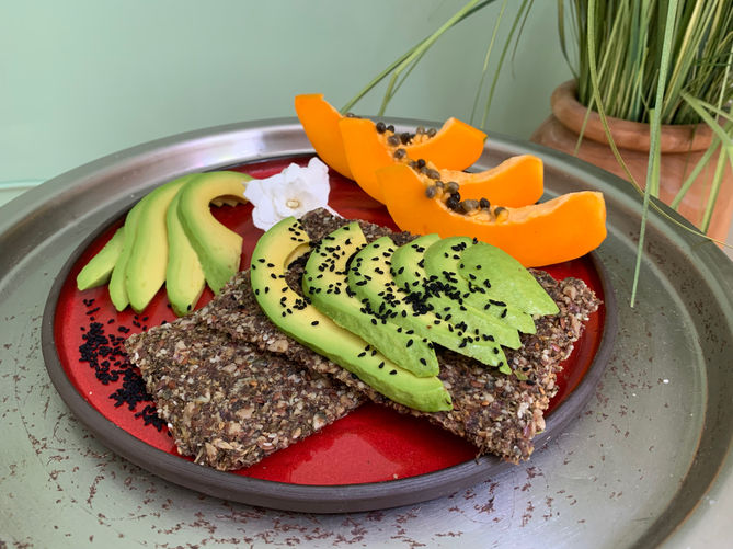 Gluten free raw vegan bread with avocado, papaya and black cumin