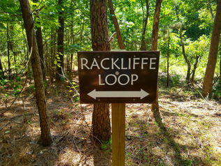 A sign in the woods that says Rackliffe loop