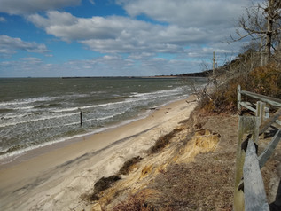 An elevated view of a beach and a choppy Bay