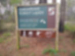a sign in the woods welcoming people to Chesapeake Forest Lands