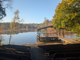 An amphitheater and stage on a dock look out over a pond