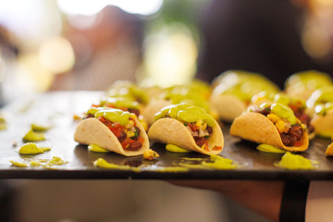 Tray of mini tacos with avocado crema, delicious and festive food