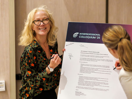 A women smiling, signing an outcome statement 