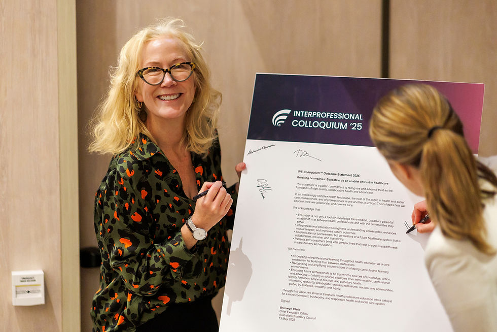 A women smiling, signing an outcome statement 