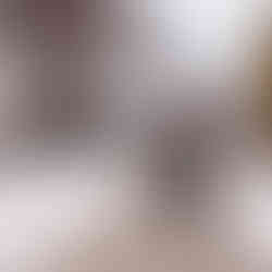 A couple walks hand-in-hand on a snowy Chicago Riverwalk path, surrounded by leafless trees and buildings. They appear happy and relaxed. Chicagoland Wedding Photographer, Chicagoland Proposal Photographer, Chicagoland Engagement Photographer, Geneva Wedding Photographer, Chicago Riverwalk engagement session, snowy chicago engagement session, winter chicago engagement session