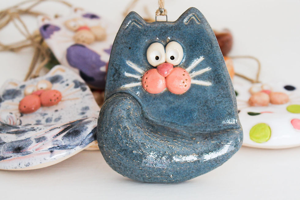 Hand-sculpted ceramic wall cat with textured fur and colorful finish
