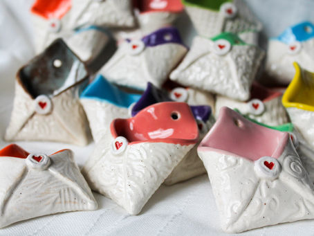 Small handmade ceramic envelopes from Veseto Ceramics, each unique and textured, made for keeping heartfelt wishes, sweet surprises, or messages of kindness.