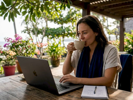 Woman browsing vacation rentals on laptop in home office