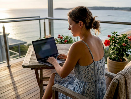 Woman browsing beach rental listings on balcony