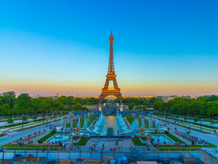 Sunset beyond the city of Paris with the Eiffel Tower alone above the horizon