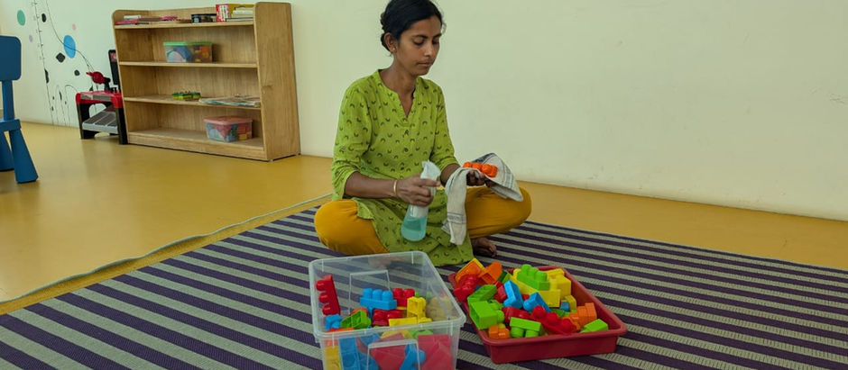 Day Care Staff cleaning the toys after use.