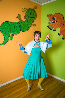 Risa in her handmade outfit surrounded by her giant 2D puppets