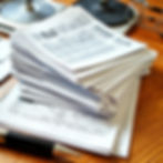 Stack of financial papers on a desk.jpg