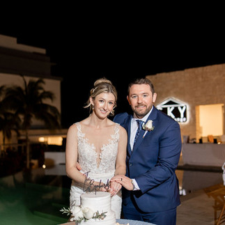 Bride and groom cutting their wedding cake.