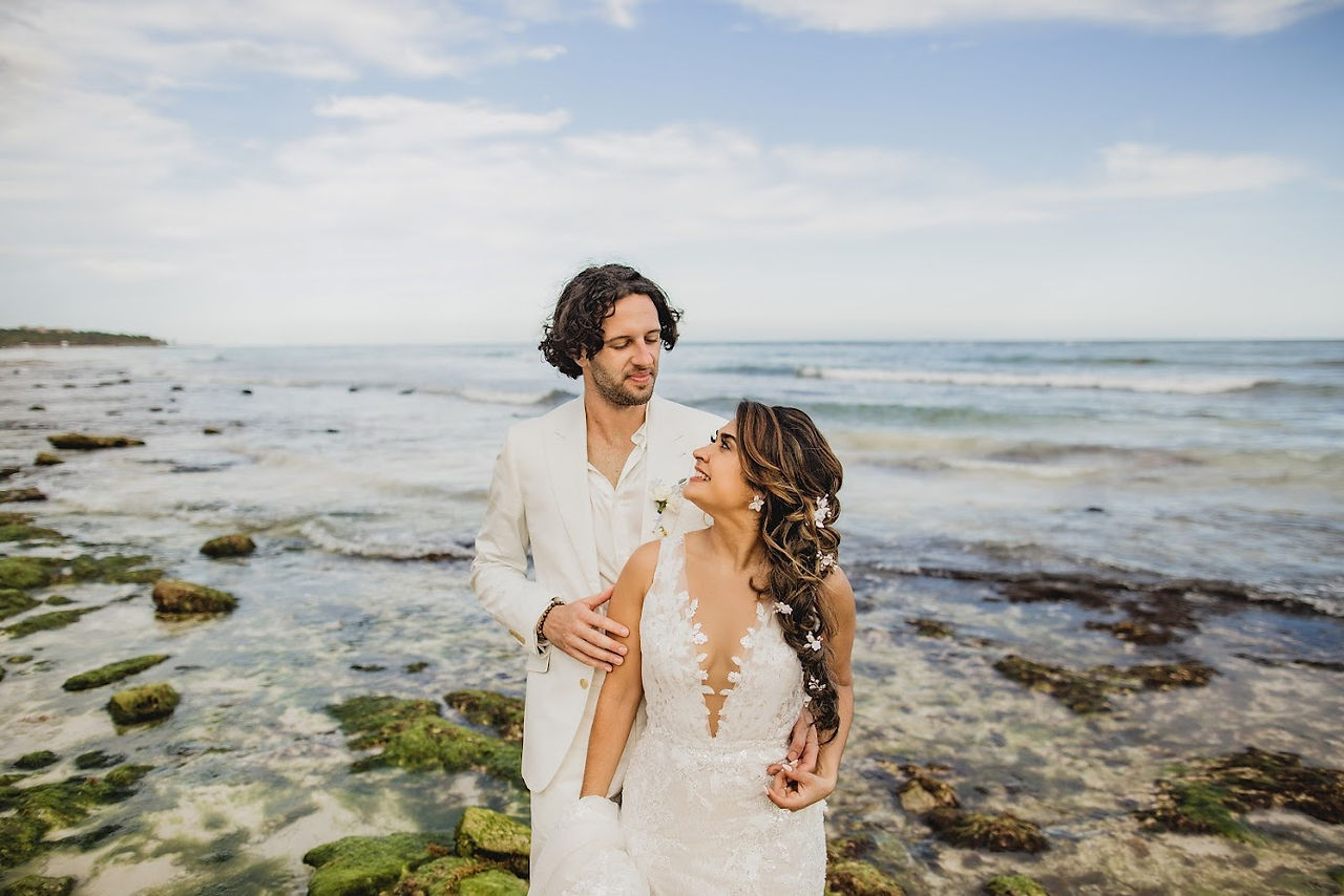 Bride and groom by ocean at their all inclusive wedding at Unico Riviera Maya in Mexico planned by travel agent for destination weddings, EverAfter Travel.