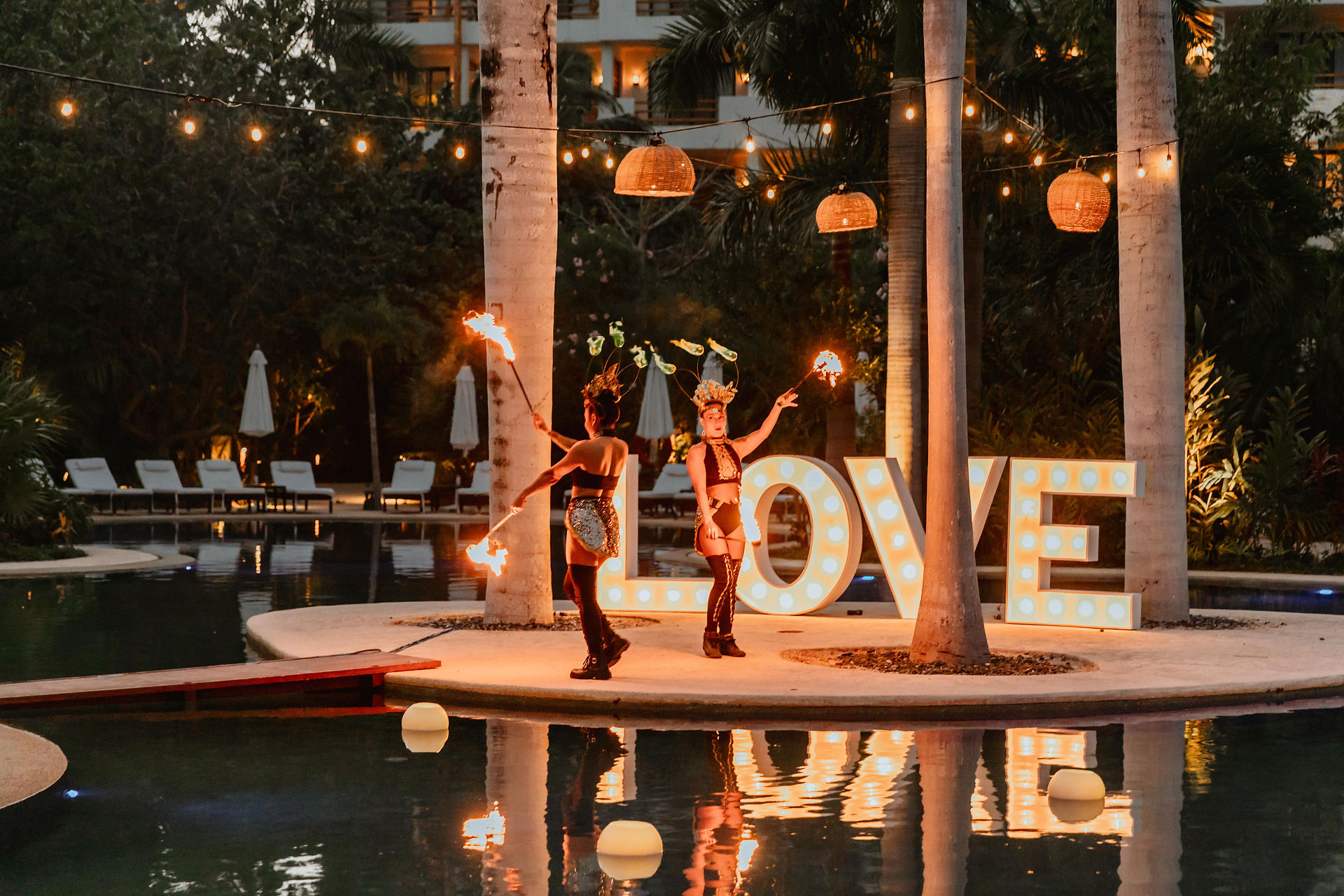 Fire dancers at all inclusive wedding at Secrets Akumal in Mexico planned by travel agent for destination weddings, EverAfter Travel.