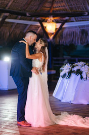 Bride and groom's first dance at their wedding reception at the Seaside Grill venue at Dreams Royal Beach.