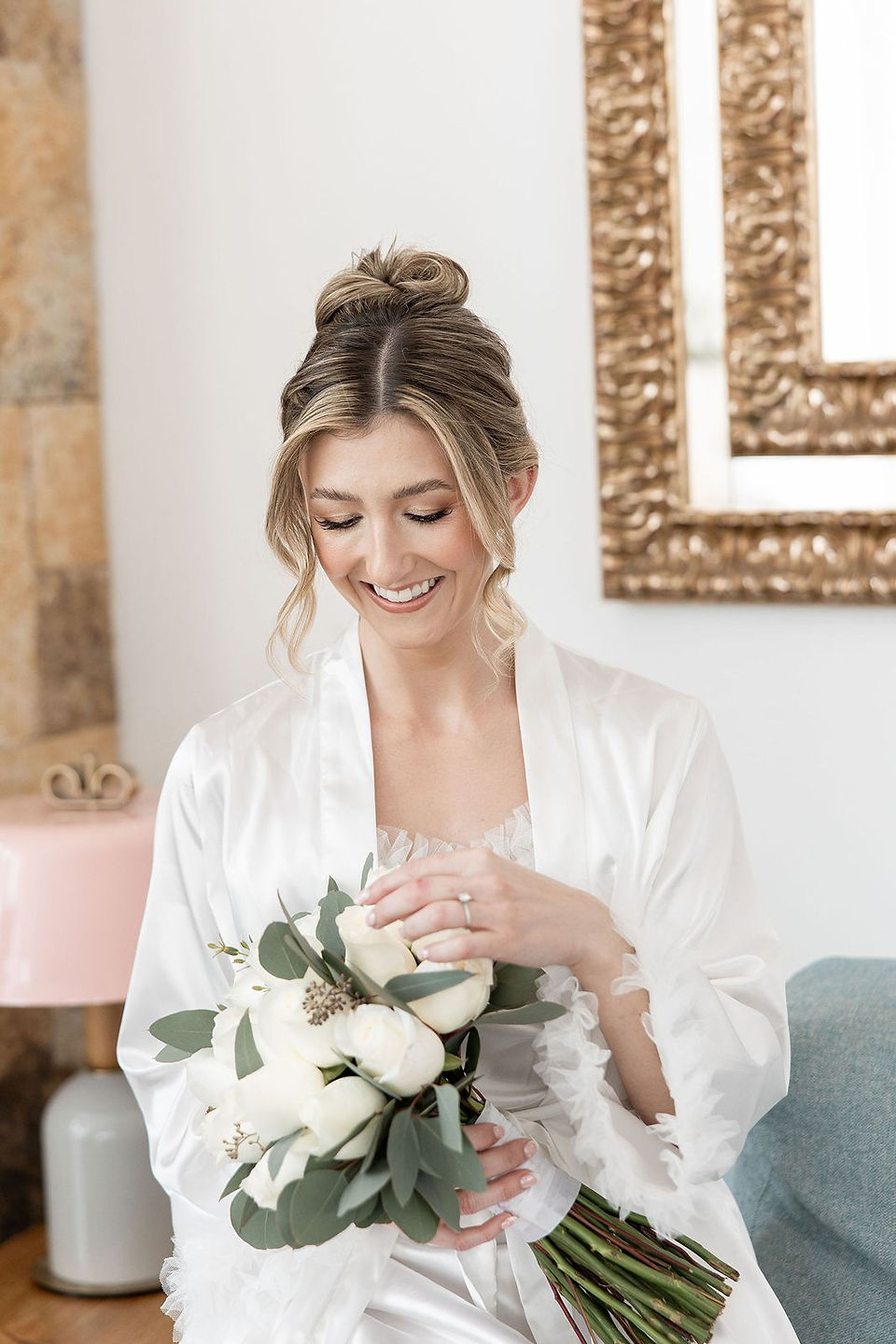 Bride looking at beautiful white bouquet.