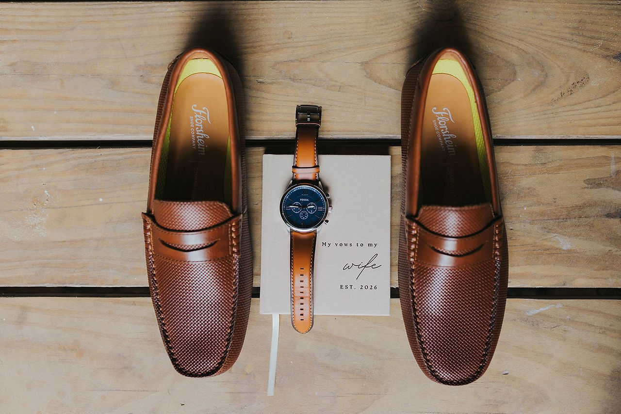 Groom's brown dress shoes and watch.