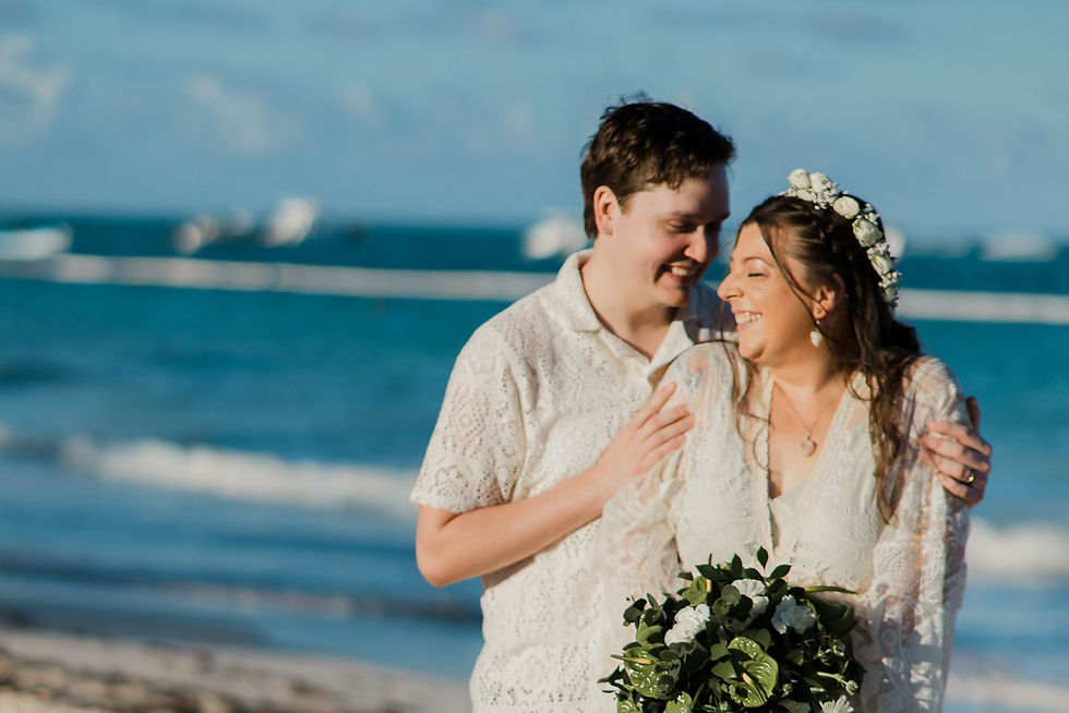 Bride and groom smiling on Bavaro Beach at their Dreams Royal Beach wedding.