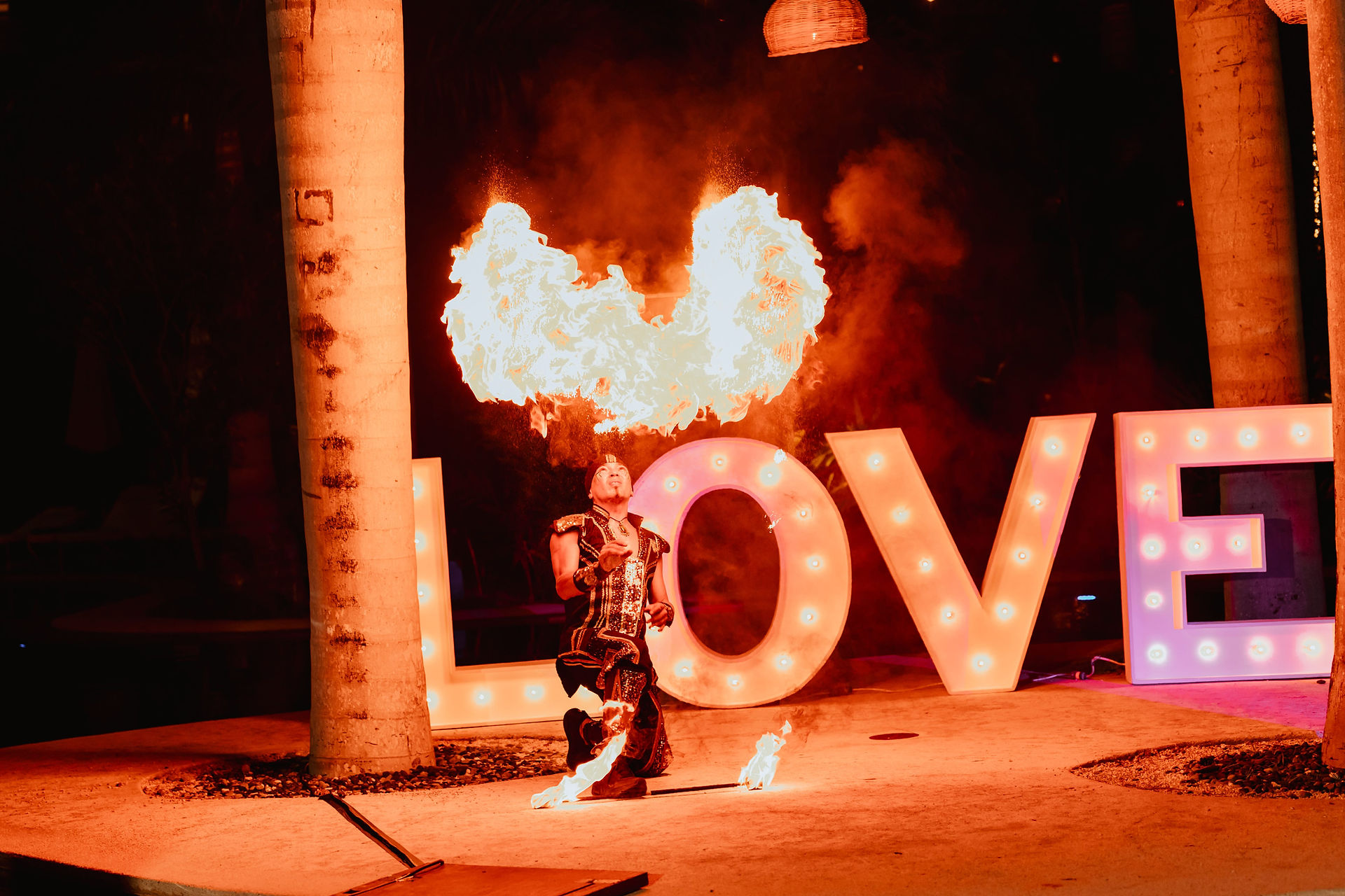 Fire dancer at all inclusive wedding at Secrets Akumal in Mexico planned by travel agent for destination weddings, EverAfter Travel.