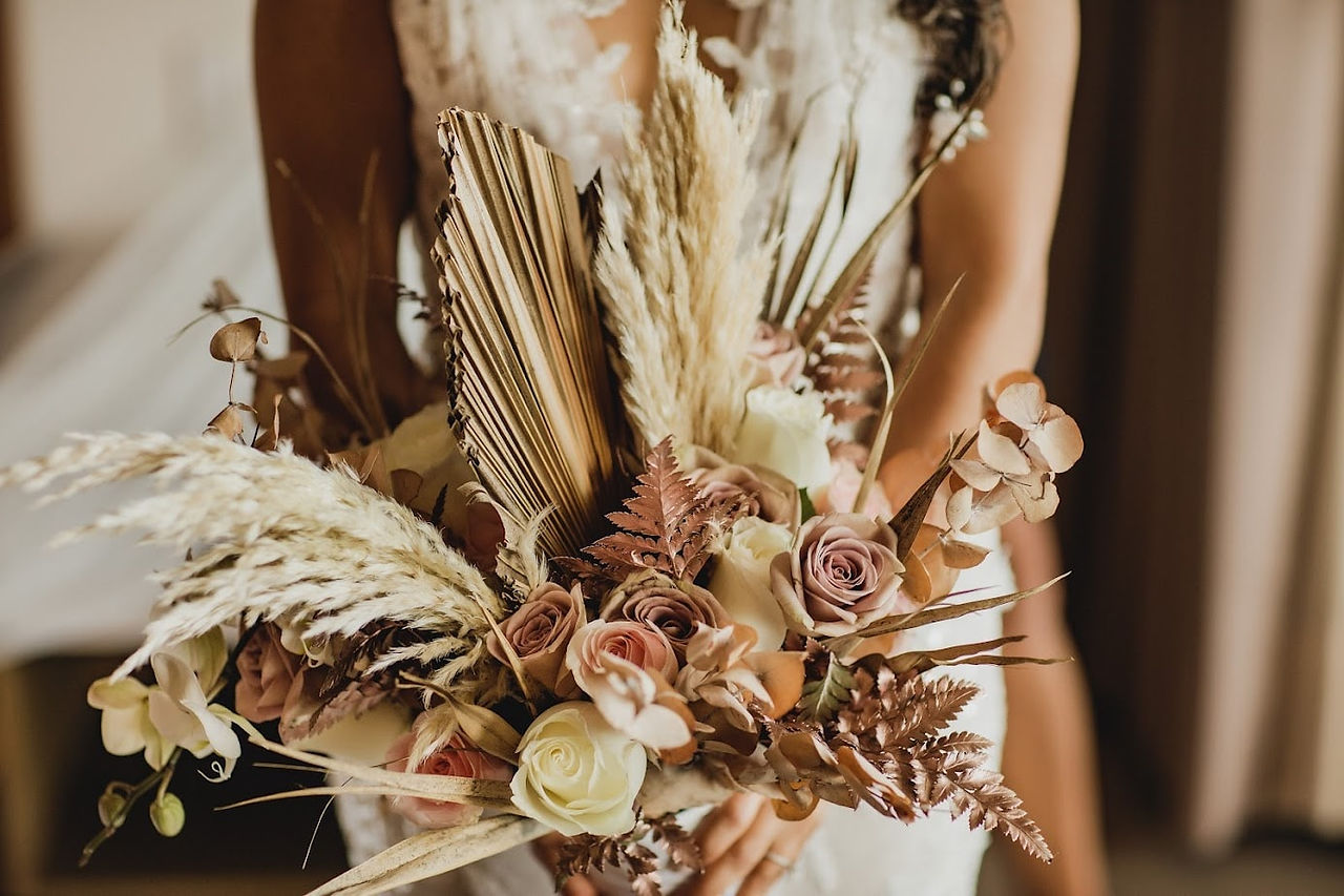 Bride's bouquet at her all inclusive wedding at Unico Riviera Maya in Mexico planned by travel agent for destination weddings, EverAfter Travel.