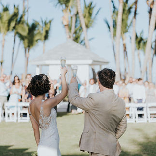 Bride and groom turning around to toast their destination wedding guests with champagne.