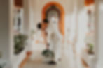 Groom dipping bride and kissing her in the middle of a Mexican architecture building at their Dreams Sapphire wedding.