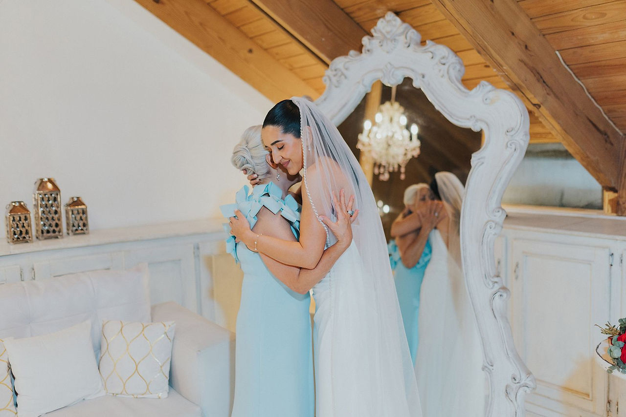 Bride hugging her mom.