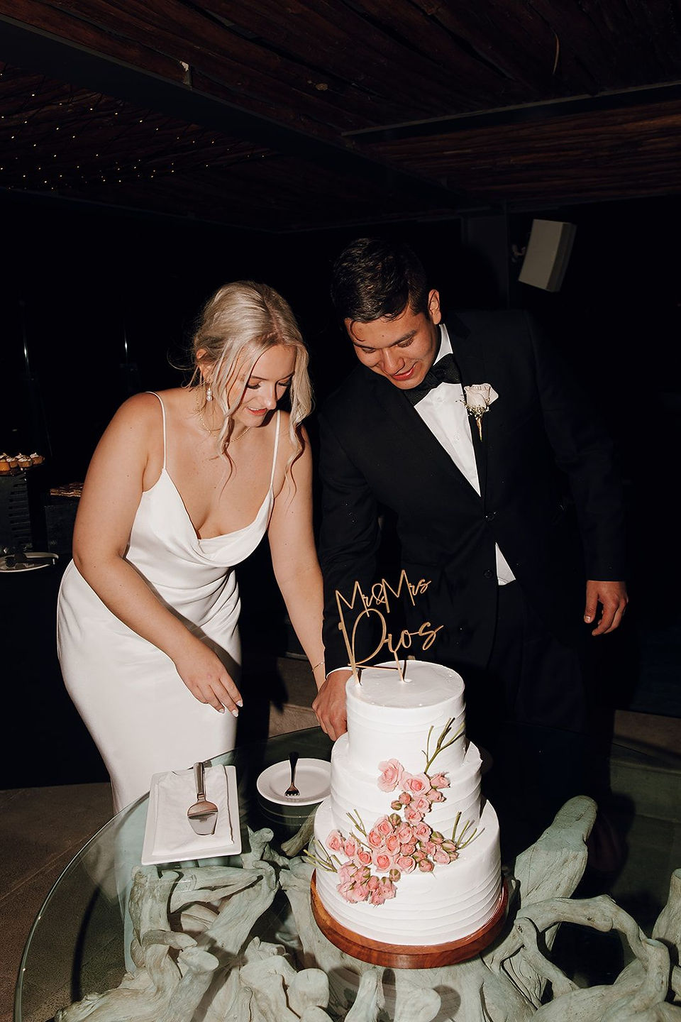 Bride and groom cutting their wedding cake.
