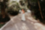 Bride and groom kissing on path in lush greenery at their Dreams Sapphire wedding in Mexico.