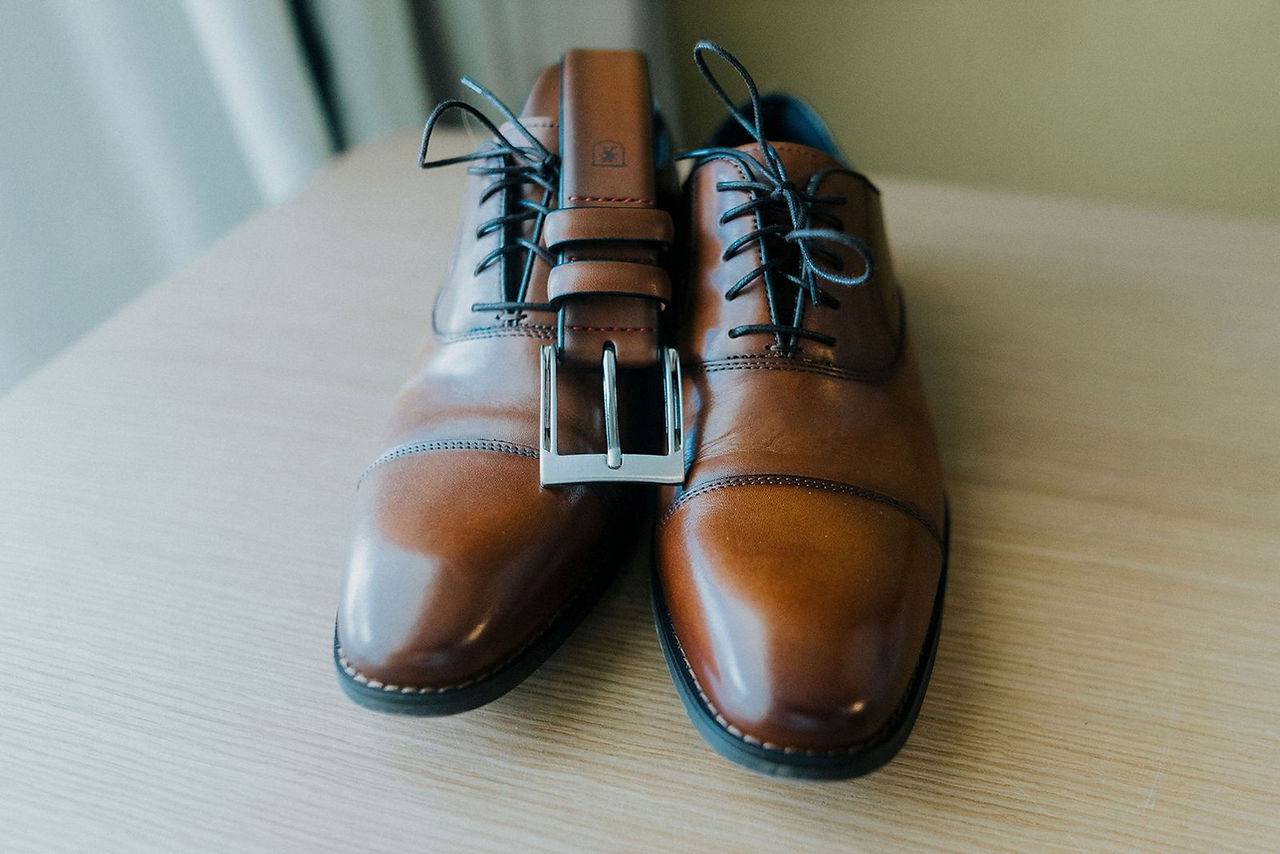 Destination wedding groom's brown dress shoes.