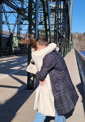 Dreams Playa Mujeres wedding couple hugging after proposal on lift bridge in Stillwater.