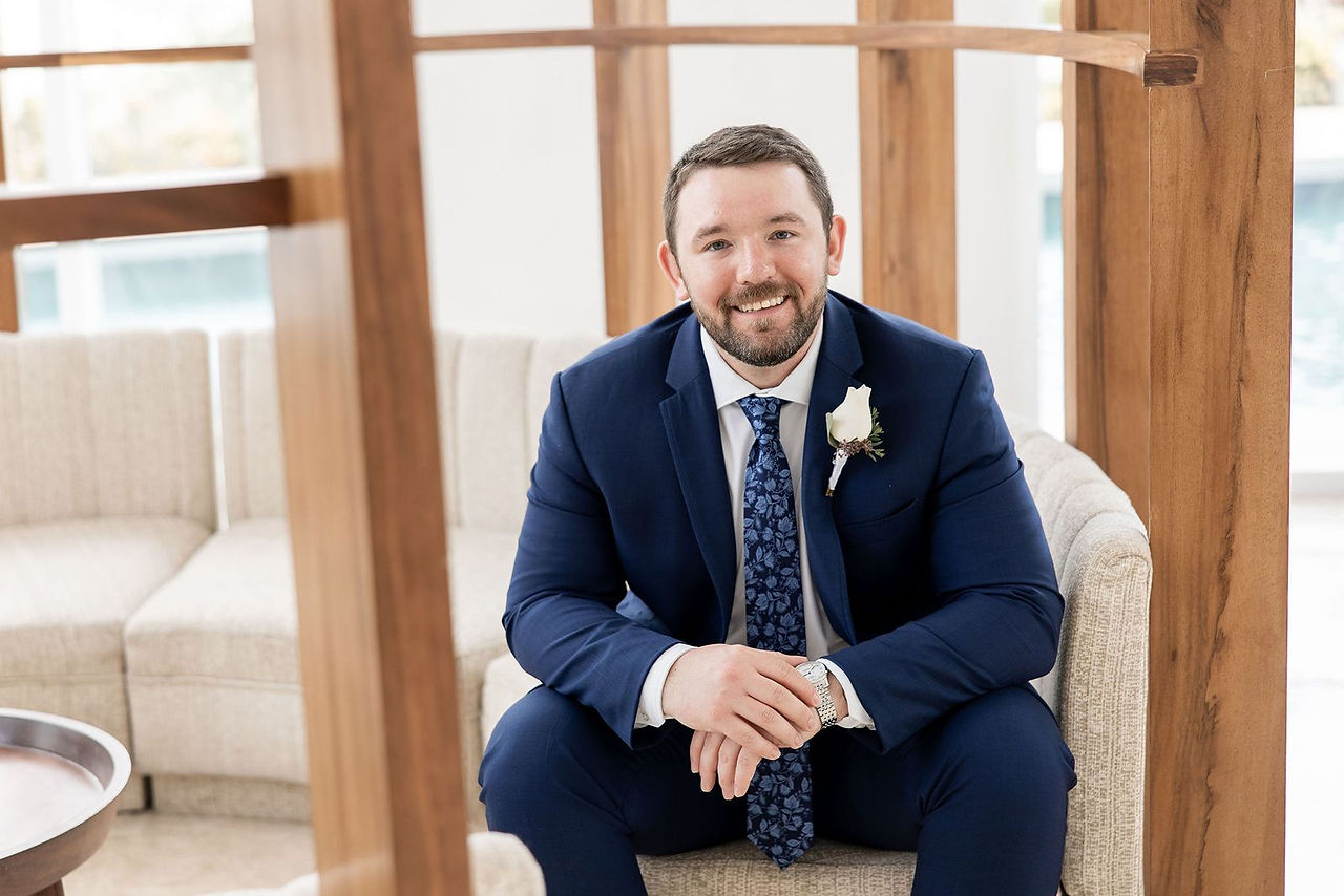 Destination wedding groom in navy suit at Majestic Elegance Costa Mujeres in Mexico.