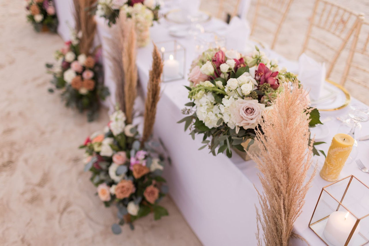 Beach wedding reception floral centerpieces with boho vibe.