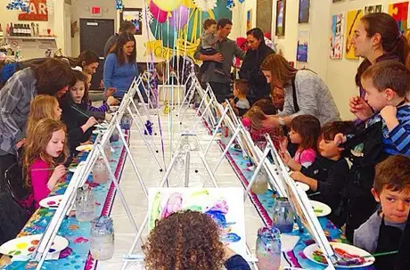 Children and parents enjoying a painting party together, participating in a fun activity inspired by art classes Halifax, fostering creativity and family bonding.