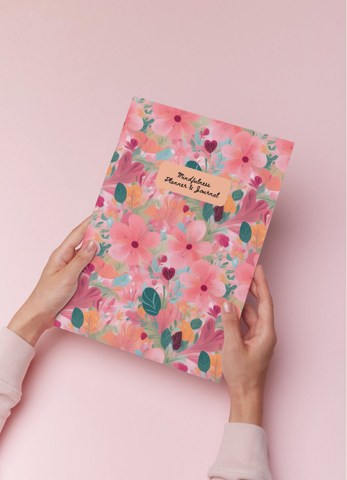 Hands hold floral patterned planner with text: Mindful Planner & Journal, Mindful Journals.
