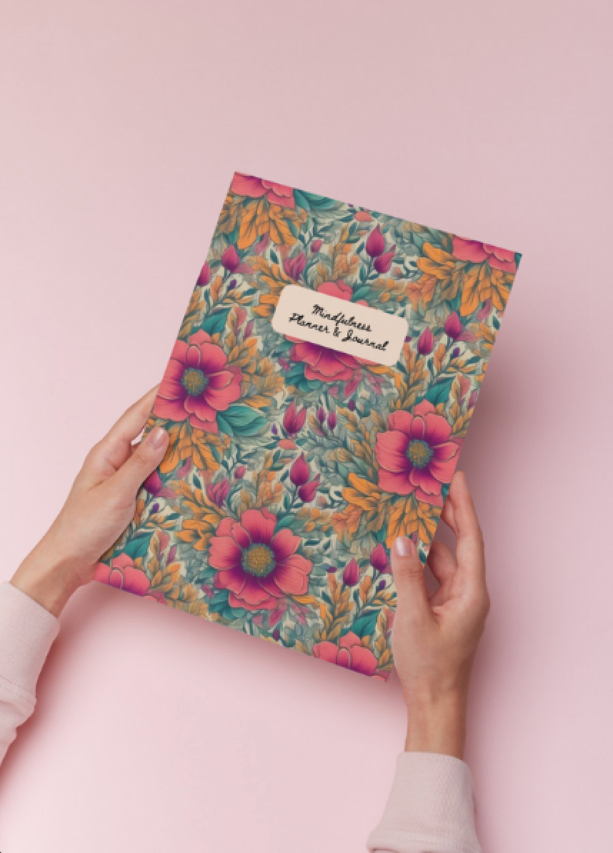 Hands holding a floral journal with the text: Mindful Planner & Journal Mindful Journals