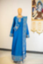 Full front view of the blue deacon sticharion with red and white embroidery, displayed on a mannequin