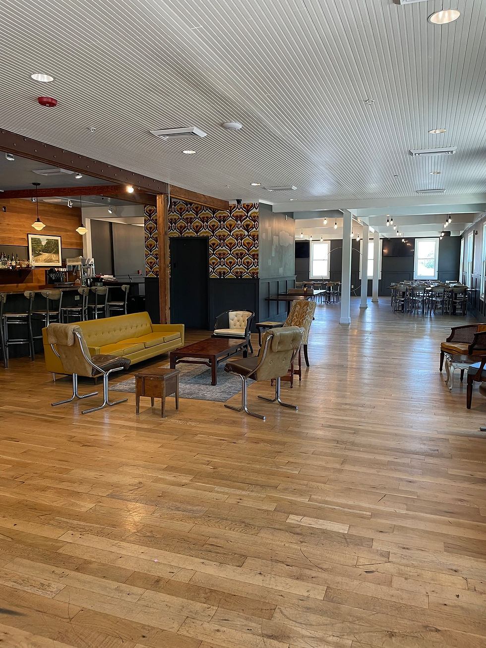 Louisville event space with wooden floors, bar, and seating