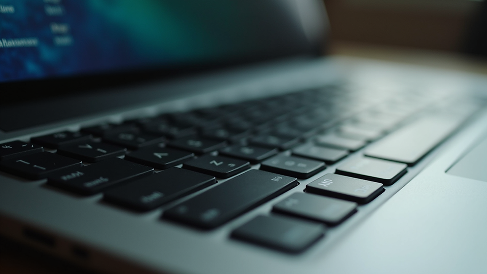 Close-up view of an older laptop keyboard and screen