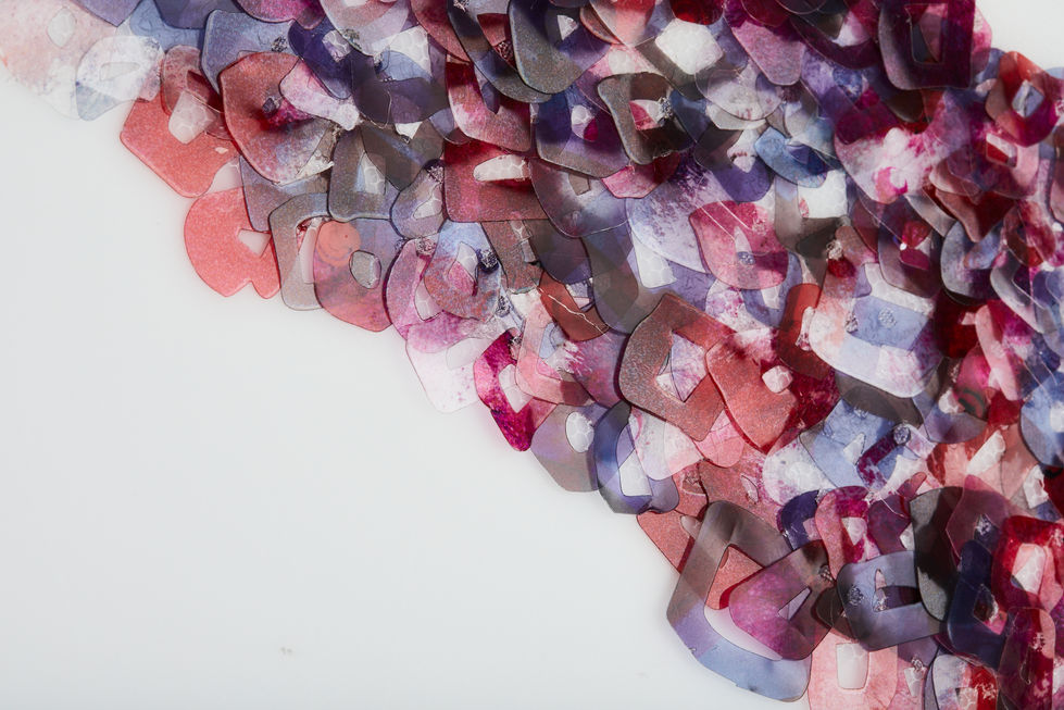 Laser cut acetate sequins.