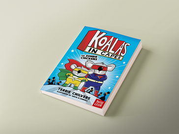 Cartoon book cover titled "Koalas in Capes" features koalas in superhero costumes. Bright blue background with stars and bold text.