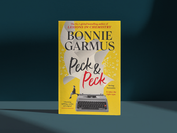 Yellow book cover of Bonnie Garmus’s novel Peck & Peck, with a typewriter and small seated figure, on a dark teal background