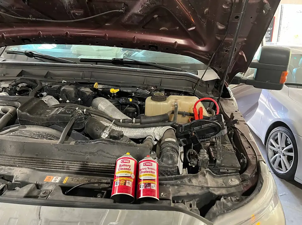 Truck battery maintenance with corrosion prevention products and jumper cables ready for a jumpstart, ensuring efficient roadside assistance.