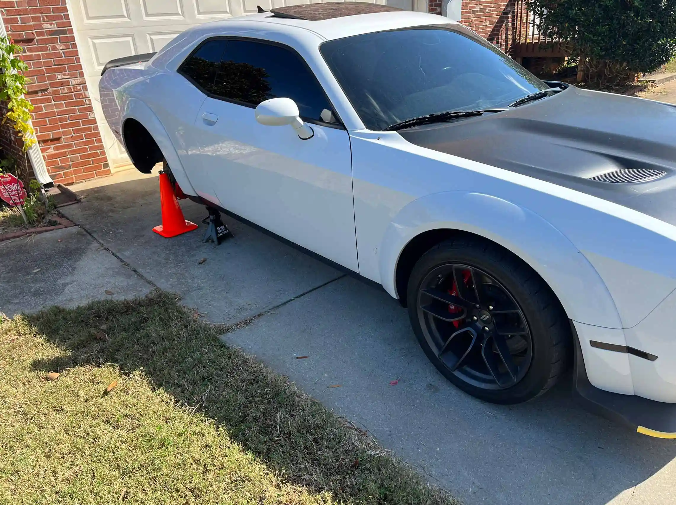 White Dodge charger needing mobile tire removal and mount services