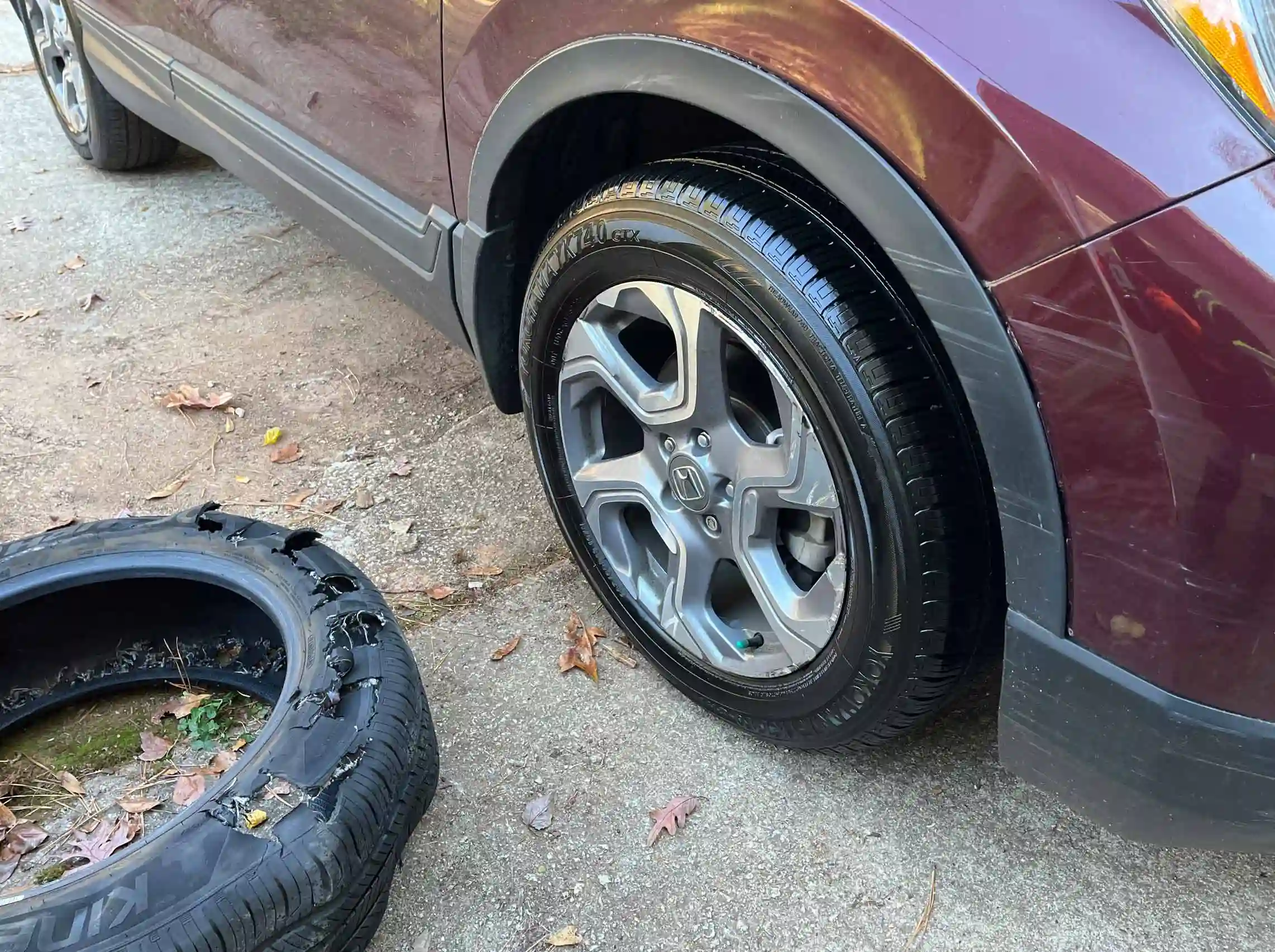 Old tire next to new tire replacement for mobile service