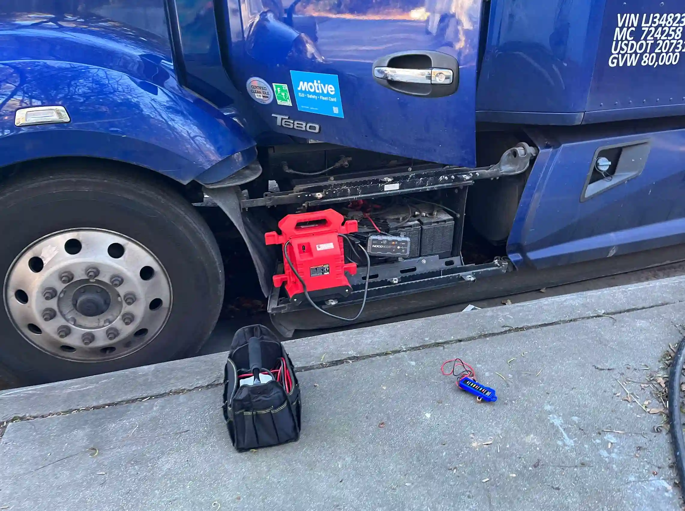 Mobile jump-start service starting semi truck with jumper box.