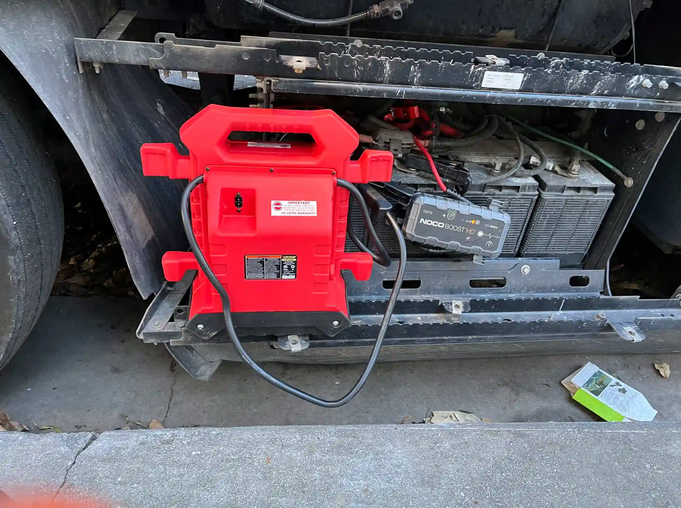 Mobile jump-start service starting semi truck with jumper box.